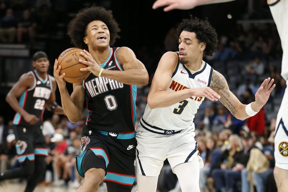 Mar 18, 2026; Memphis, Tennessee, USA; Memphis Grizzlies forward Jaylen Wells (0) drives to the basket as Denver Nuggets guard Julian Strawther (3) defends during the second quarter at FedExForum. Mandatory Credit: Petre Thomas-Imagn Images