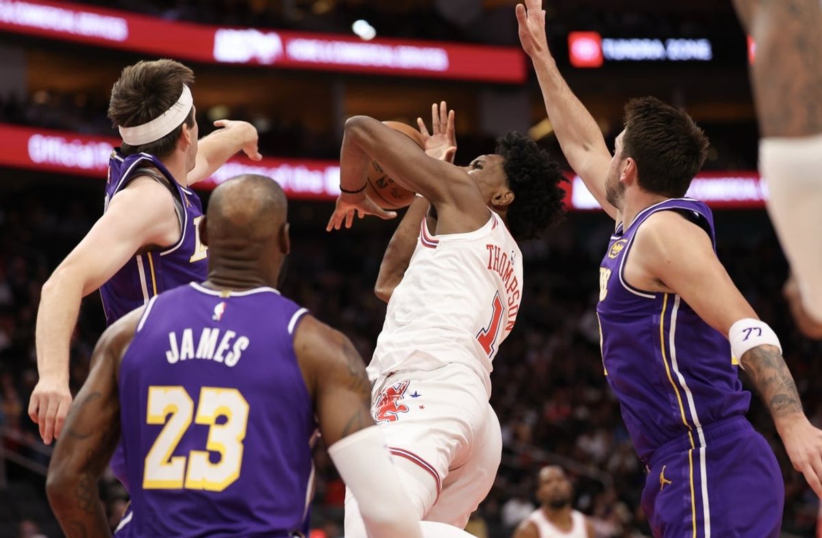 Mar 18, 2026; Houston, Texas, USA; Houston Rockets guard Amen Thompson (1) drives to the basket against Los Angeles Lakers guard Austin Reaves (15) and guard Luka Doncic (77)  in the first quarter at Toyota Center. Mandatory Credit: Thomas Shea-Imagn Images