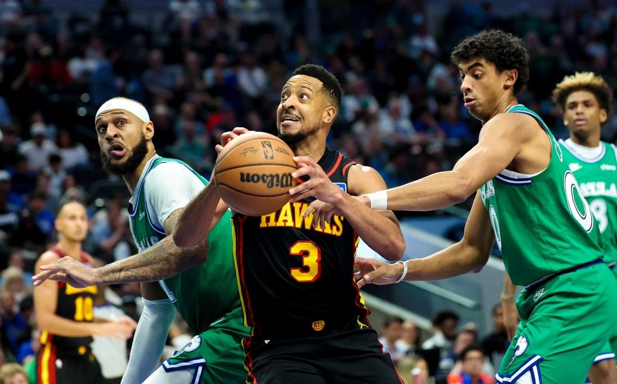 Mar 18, 2026; Dallas, Texas, USA; Atlanta Hawks guard CJ McCollum (3) shoots as Dallas Mavericks forward Daniel Gafford (21) and Dallas Mavericks guard Max Christie (00) defend during the second half at American Airlines Center. Mandatory Credit: Kevin Jairaj-Imagn Images
