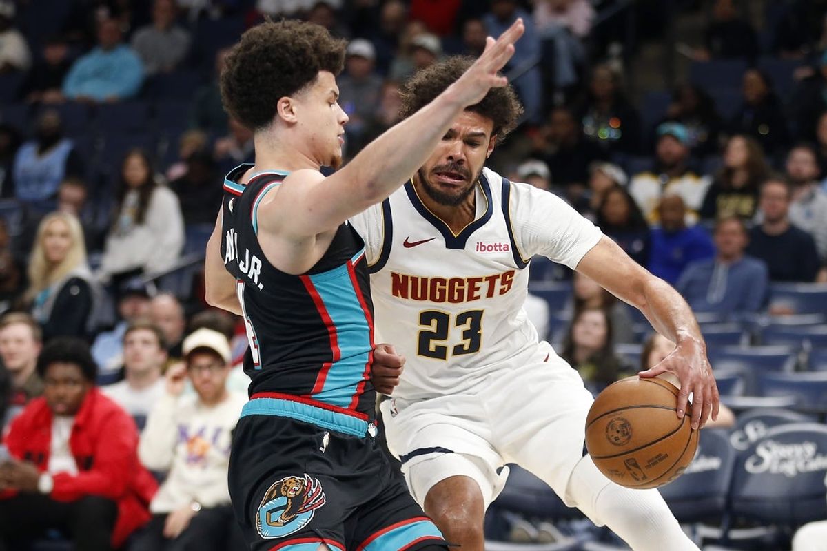 Mar 18, 2026; Memphis, Tennessee, USA; Denver Nuggets forward Cameron Johnson (23) drives to the basket as Memphis Grizzlies guard Walter Clayton Jr. (4) defends during the fourth quarter at FedExForum. Mandatory Credit: Petre Thomas-Imagn Images