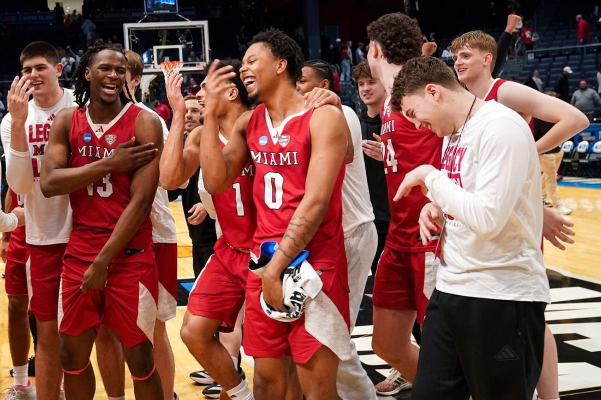 Miami (OH) RedHawks players and staff celebrate after defeating the Southern Methodist University Mustangs 89-79, Wednesday, March 18, 2026, at University of Dayton Arena in Dayton, Oh.