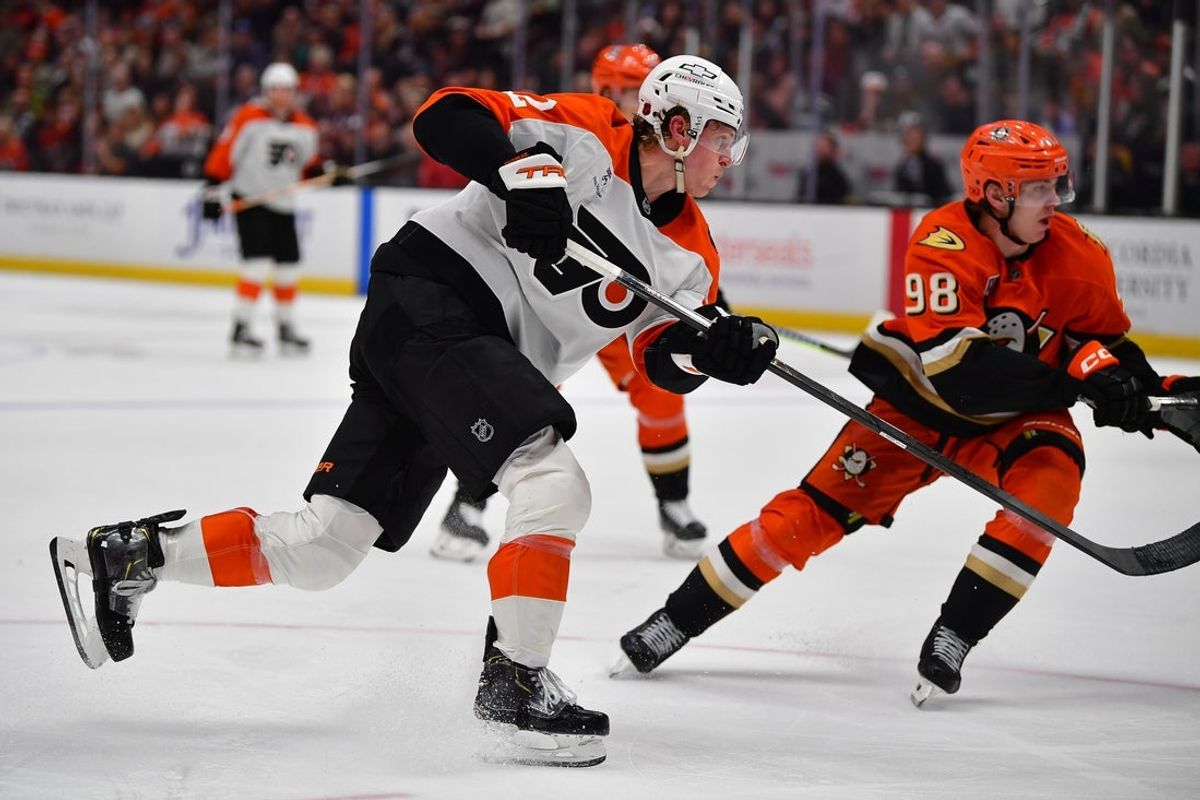 Mar 18, 2026; Anaheim, California, USA; Philadelphia Flyers center Christian Dvorak (22) shoots on goal against Anaheim Ducks defenseman Pavel Mintyukov (98) during the third period at Honda Center. Mandatory Credit: Gary A. Vasquez-Imagn Images
