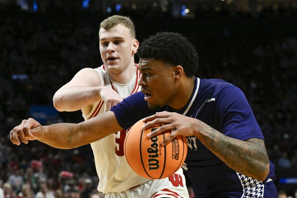 Mar 19, 2026; Portland, OR, USA; High Point Panthers forward Owen Aquino (8) drives to the basket against Wisconsin Badgers forward Aleksas Bieliauskas (32) during the second half of a first round game of the men's 2026 NCAA Tournament at Moda Center. Mandatory Credit: Craig Strobeck-Imagn Images