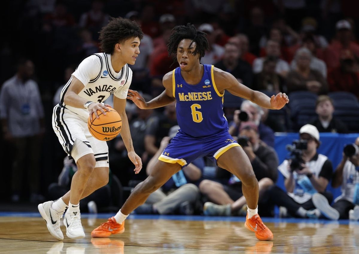 Mar 19, 2026; Oklahoma City, OK, USA; Vanderbilt Commodores guard Tyler Tanner (3) drives to the hoop past McNeese Cowboys guard Larry Johnson (6) during the second half during a first round game of the men's 2026 NCAA Tournament at Paycom Center. Mandatory Credit: Alonzo Adams-Imagn Images