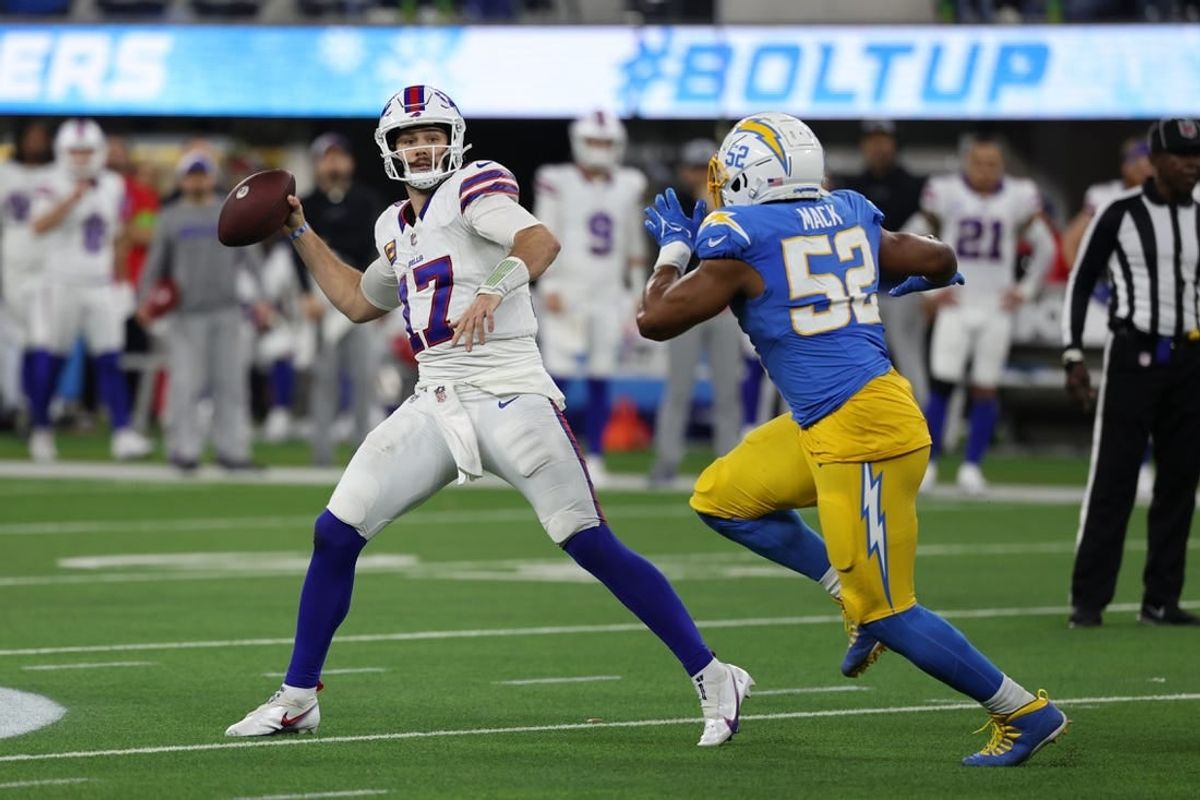 Dec 23, 2023; Inglewood, California, USA;  Buffalo Bills quarterback Josh Allen (17) throws a pass while Los Angeles Chargers linebacker Khalil Mack (52) pressuring him during the fourth quarter at SoFi Stadium.