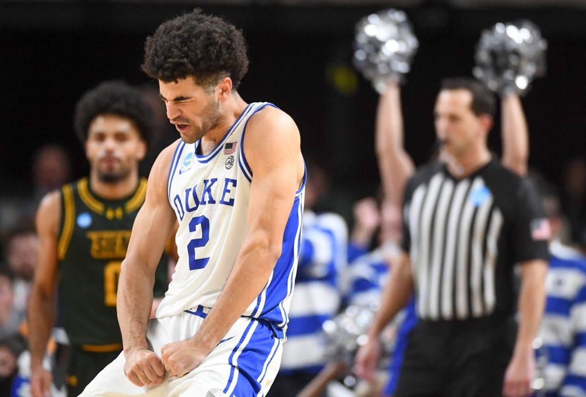 Duke Blue Devils guard Cayden Boozer (2) celebrates after scoring Thursday, March 19, 2026, during the NCAA Men’s Basketball Tournament first round game against the Siena Saints at Bon Secours Wellness Arena in Greenville, South Carolina. Duke Blue Devils won 71-65.