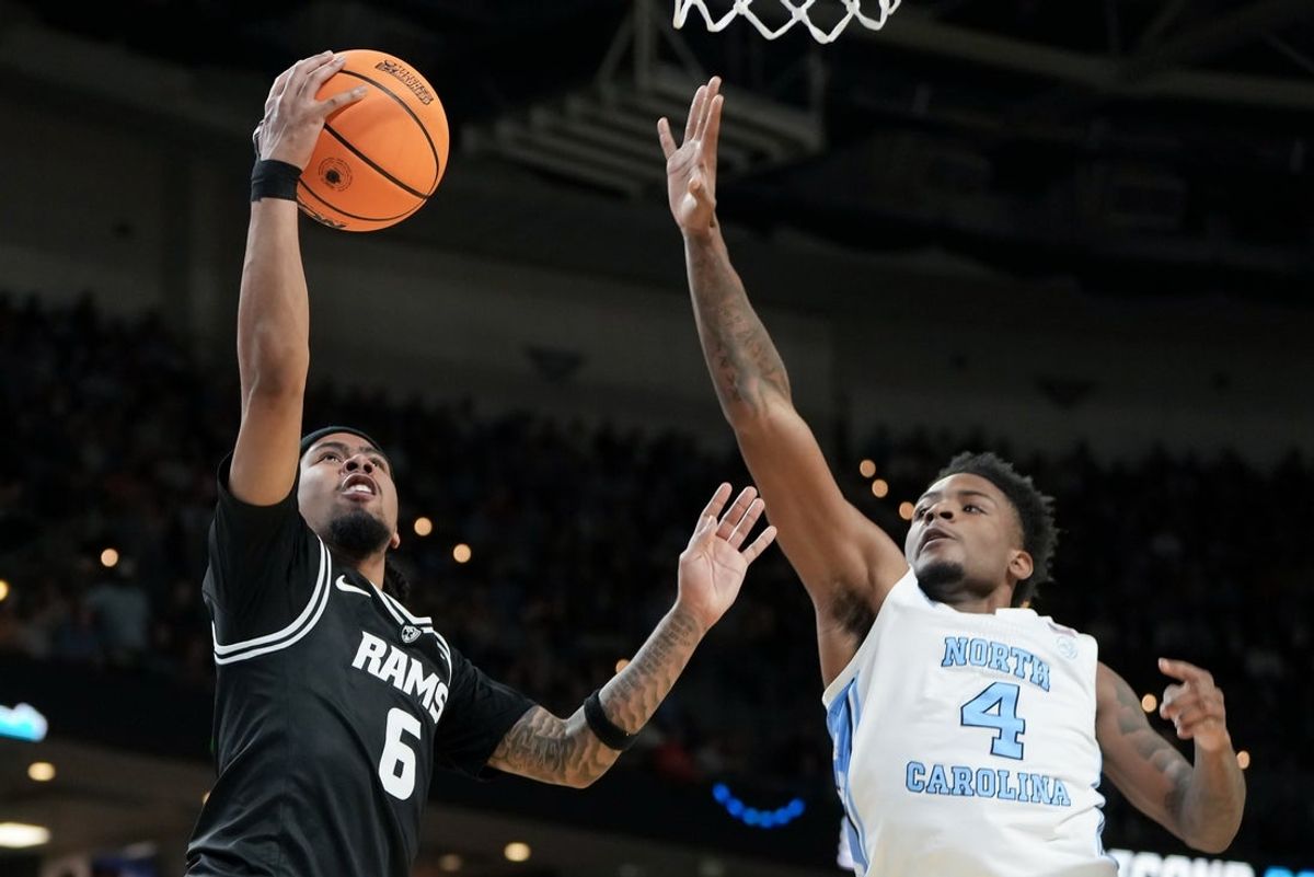 Mar 19, 2026; Greenville, SC, USA; VCU Rams guard Terrence Hill Jr. (6) shoots past North Carolina Tar Heels guard Jaydon Young (4) in the first half of a first round game of the men's 2026 NCAA Tournament at Bon Secours Wellness Arena. Mandatory Credit: Bob Donnan-Imagn Images