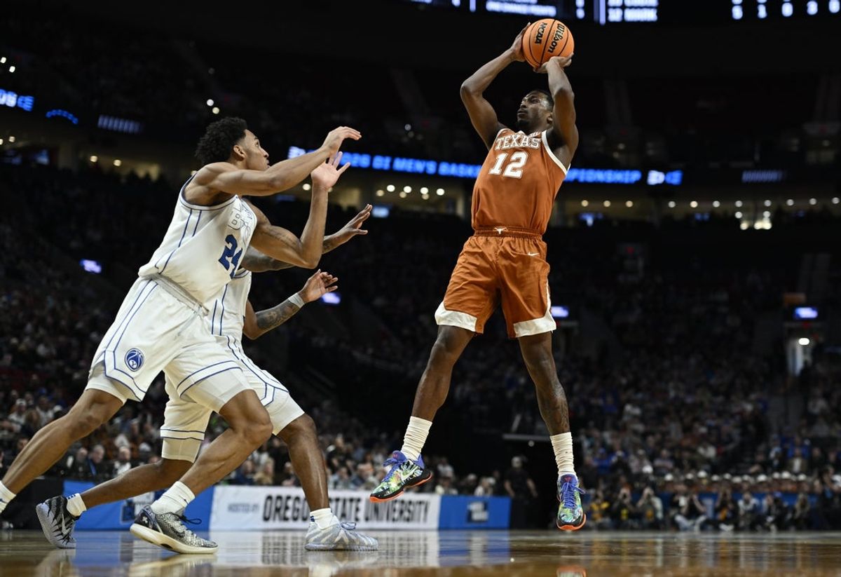 Mar 19, 2026; Portland, OR, USA; Texas Longhorns guard Tramon Mark (12) shoots against BYU Cougars forward Dominique Diomande (24) in the first half during a first round game of the men's 2026 NCAA Tournament at Moda Center. Mandatory Credit: Troy Wayrynen-Imagn Images
