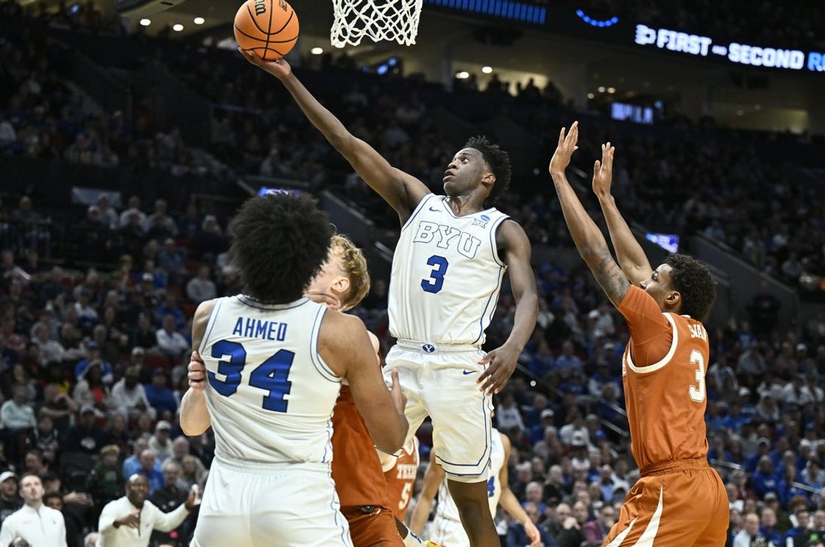 Mar 19, 2026; Portland, OR, USA; BYU Cougars forward AJ Dybantsa (3) shoots against Texas Longhorns forward Dailyn Swain (3) in the first half during a first round game of the men's 2026 NCAA Tournament at Moda Center. Mandatory Credit: Craig Strobeck-Imagn Images