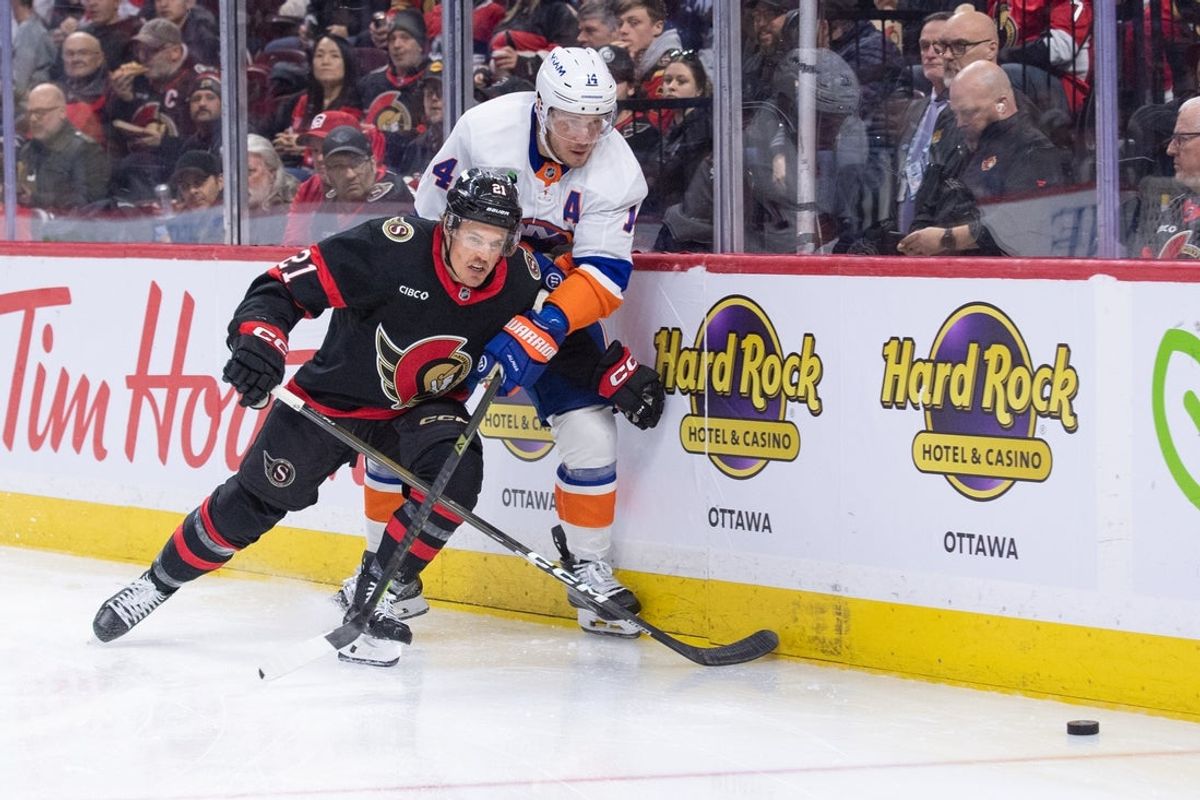 Mar 19, 2026; Ottawa, Ontario, CAN; Ottawa Senators center Nick Cousins (21) and New York Islanders center Bo Horvat (14) chase the puck in the second period at the Canadian Tire Centre. Mandatory Credit: Marc DesRosiers-IMAGN Images