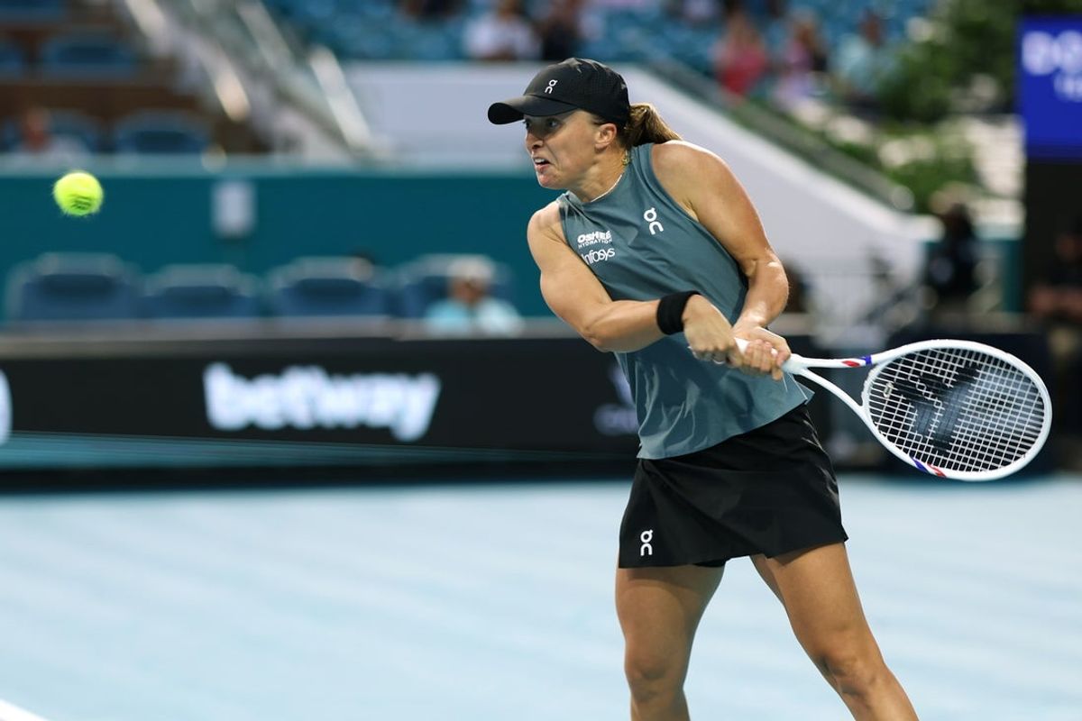 Mar 19, 2026; Miami Gardens, FL, USA; Iga Swiatek (POL) hits a backhand against Magda Linette (POL) (not pictured) on day three of the 2026 Miami Open at Hard Rock Stadium. Mandatory Credit: Geoff Burke-Imagn Images