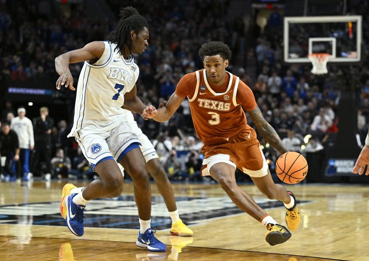 Mar 19, 2026; Portland, OR, USA; Texas Longhorns forward Dailyn Swain (3) drives against BYU Cougars forward Khadim Mboup (7) in the second half during a first round game of the men's 2026 NCAA Tournament at Moda Center. Mandatory Credit: Craig Strobeck-Imagn Images