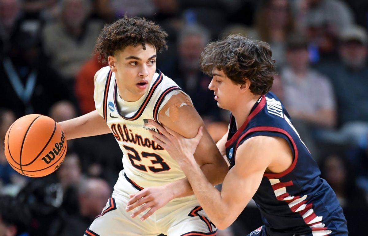 Illinois Fighting Illini guard Keaton Wagler (23) is defended by Penn Quakers guard AJ Levine (0) Thursday, March 19, 2026, during the NCAA Men’s Basketball Tournament first round game at Bon Secours Wellness Arena in Greenville, South Carolina.