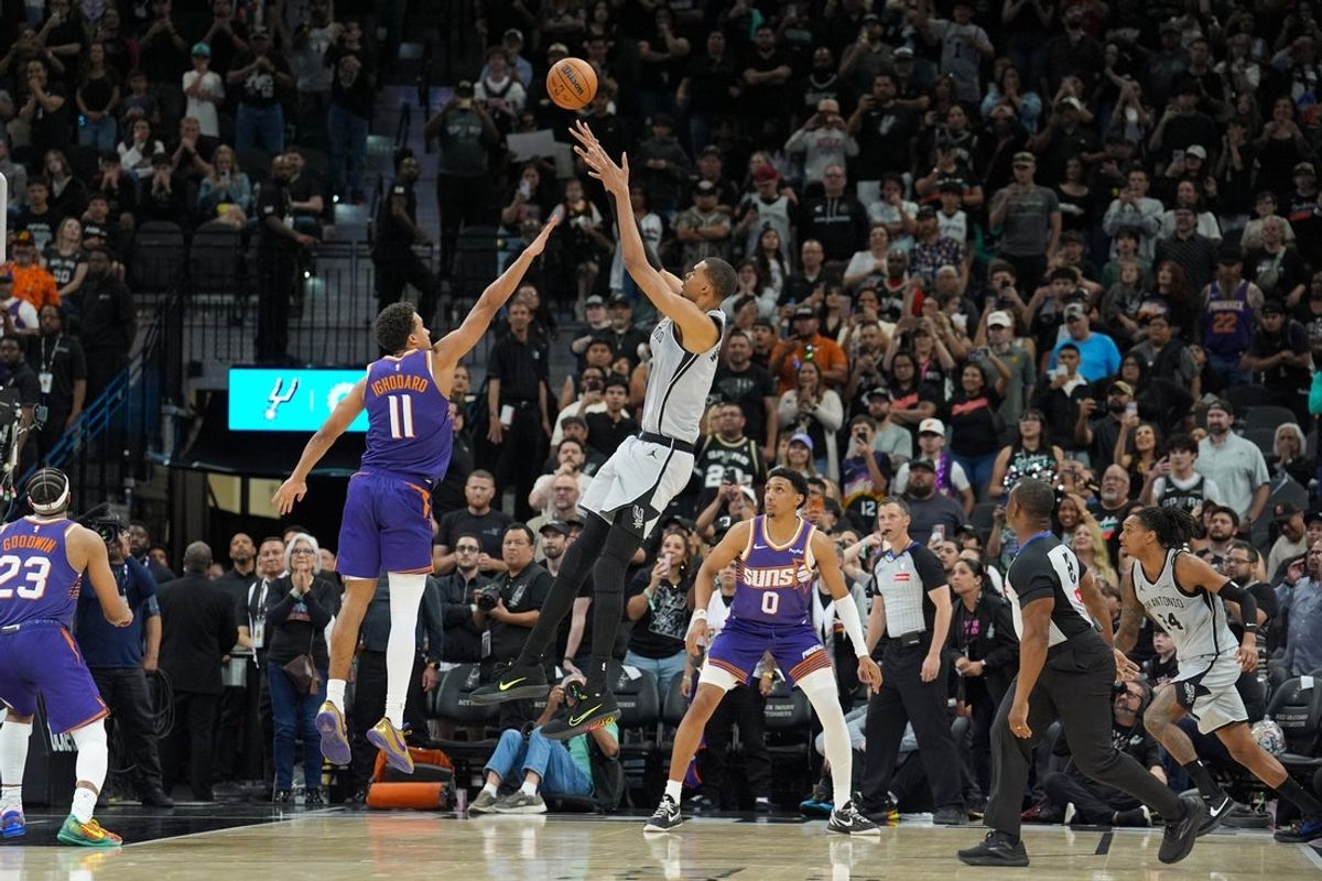 Mar 19, 2026; San Antonio, Texas, USA;  San Antonio Spurs forward Victor Wembanyama (1) shoots the game winning shot over Phoenix Suns forward Oso Ighodaro (11) in the second half at Frost Bank Center. Mandatory Credit: Daniel Dunn-Imagn Images