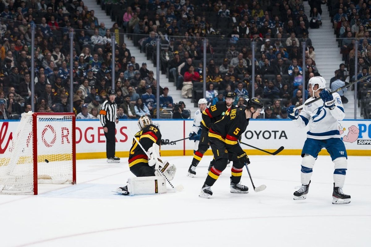 Mar 19, 2026; Vancouver, British Columbia, CAN; Vancouver Canucks defenseman Tom Willander (5) watches and the redirect form Tampa Bay Lightning forward Jake Guentzel (59) goes past Vancouver Canucks goalie Kevin Lankinen (32) in the first period at Rogers Arena. Mandatory Credit: Bob Frid-Imagn Images