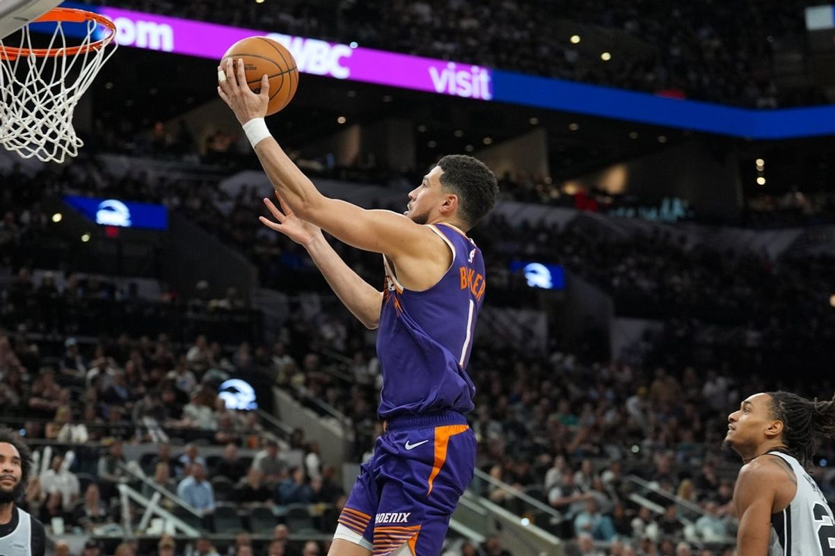 Mar 19, 2026; San Antonio, Texas, USA;  Phoenix Suns guard Devin Booker (1) lays the ball up in the second half against the San Antonio Spurs at Frost Bank Center. Mandatory Credit: Daniel Dunn-Imagn Images