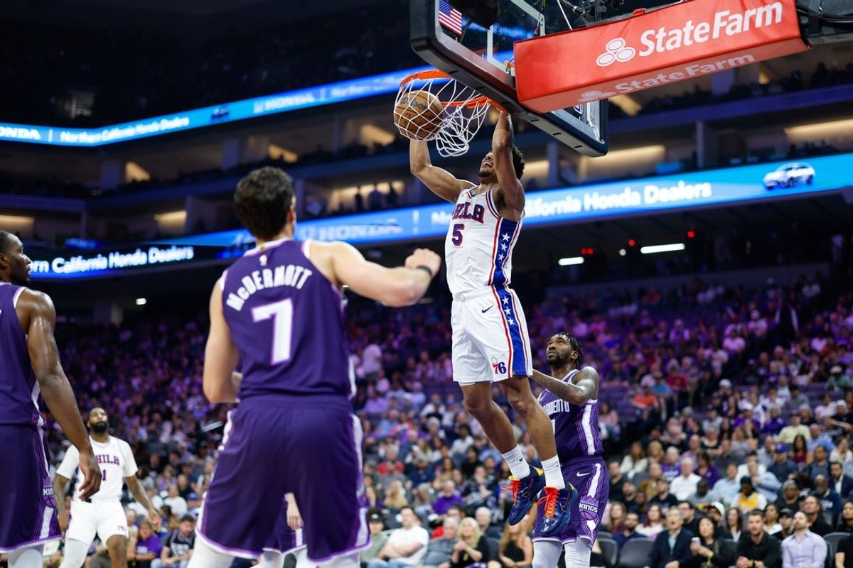 Mar 19, 2026; Sacramento, California, USA; Philadelphia 76ers guard Quentin Grimes (5) dunks the ball against Sacramento Kings guard Malik Monk (0) during the second quarter at Golden 1 Center. Mandatory Credit: Sergio Estrada-Imagn Images