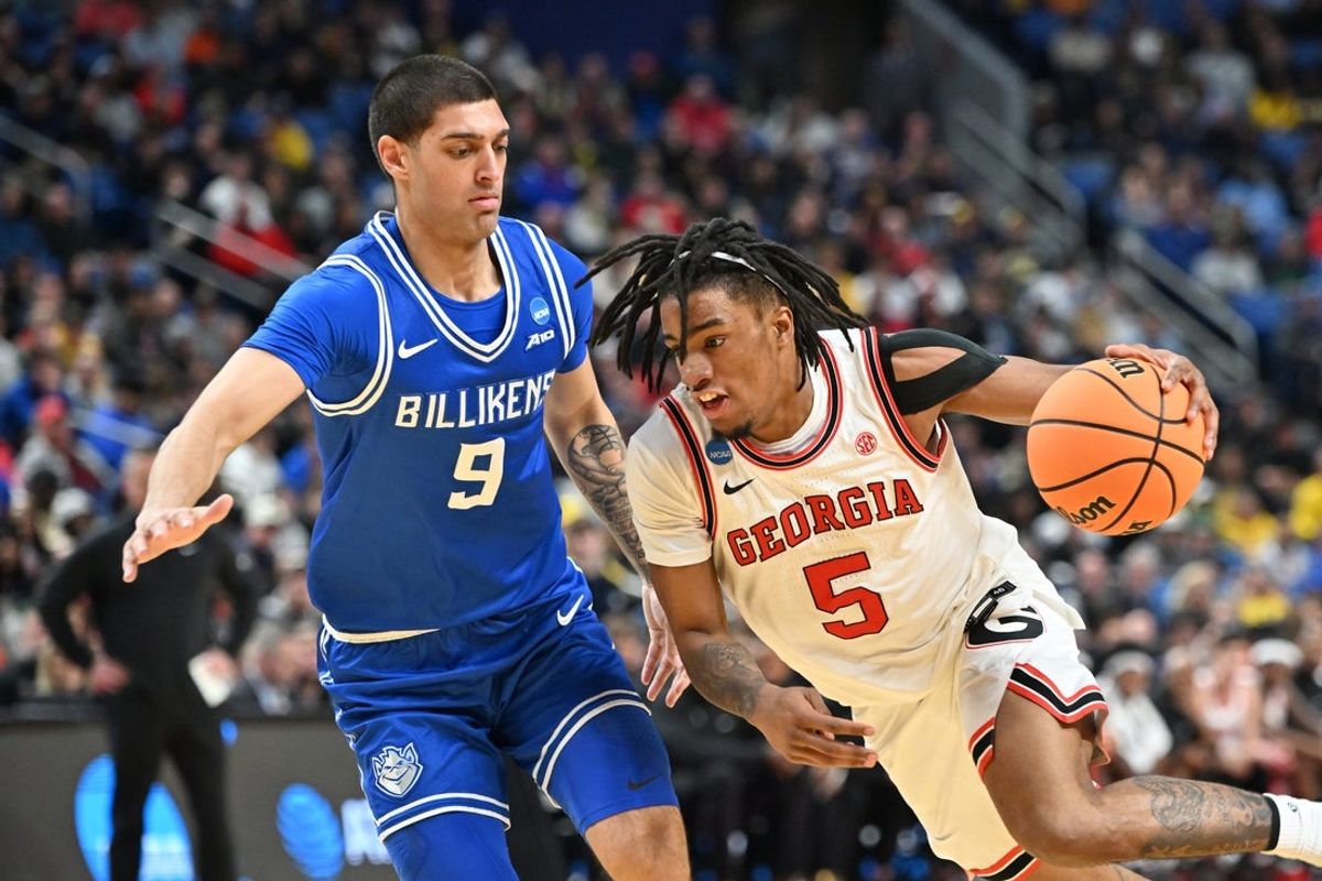 Mar 19, 2026; Buffalo, NY, USA; Georgia Bulldogs guard Jeremiah Wilkinson (5) drives to the basket against Saint Louis Billikens forward Ishan Sharma (9) during the first half of a first round game of the men's 2026 NCAA Tournament at Keybank Center. Mandatory Credit: Mark Konezny-Imagn Images