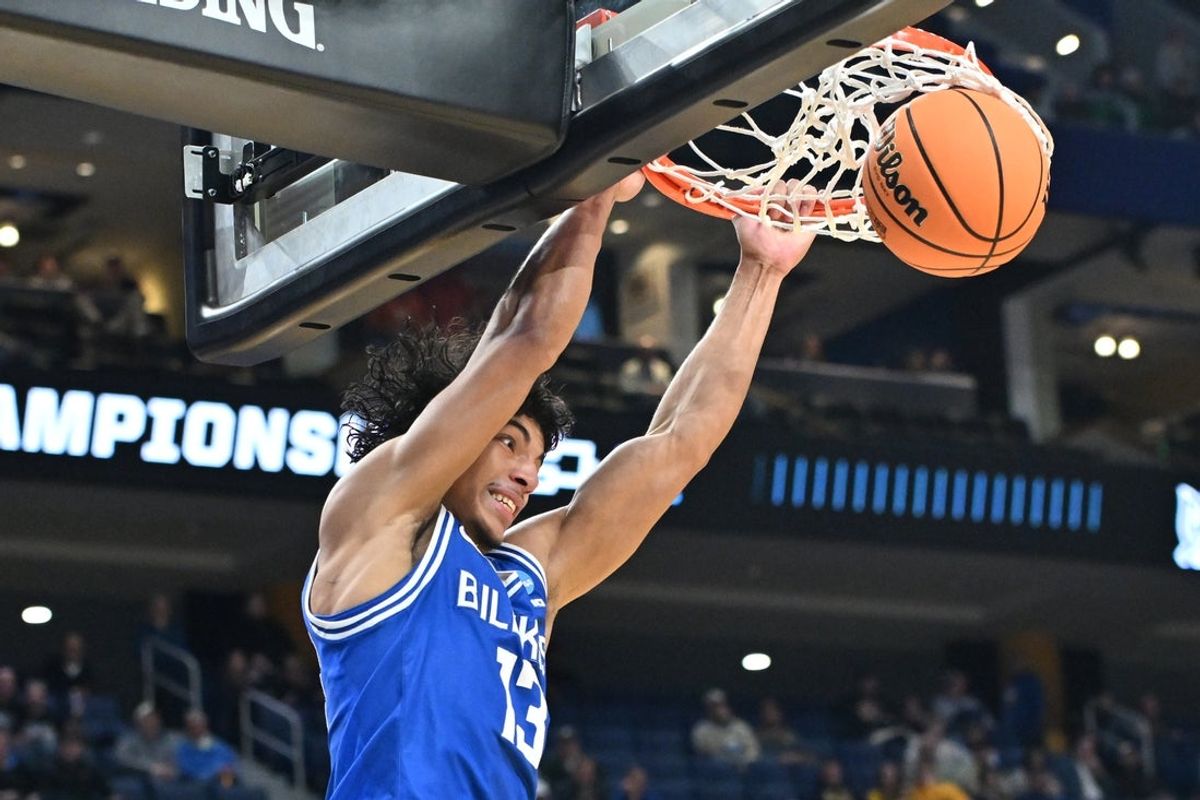 Mar 19, 2026; Buffalo, NY, USA; Saint Louis Billikens guard Dion Brown (13) dunks the ball against the Georgia Bulldogs during the second half of a first round game of the men's 2026 NCAA Tournament at Keybank Center. Mandatory Credit: Mark Konezny-Imagn Images