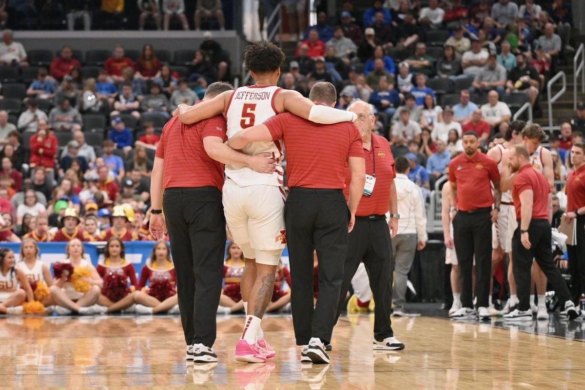 Mar 20, 2026; St. Louis, MO, USA; Iowa State Cyclones forward Joshua Jefferson (5) is helped off of the court after suffering an apparent injury to his left leg against Tennessee State Tigers during the first half of a first round game of the men's 2026 NCAA Tournament at Enterprise Center. Mandatory Credit: Jeff Curry-Imagn Images