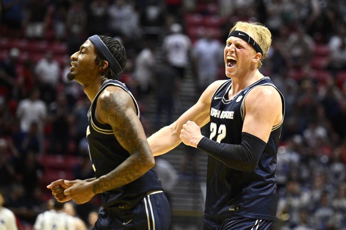 Mar 20, 2026; San Diego, CA, USA; Utah State Aggies forward Karson Templin (22) and guard Mj Collins (2) celebrate in the second half against the Villanova Wildcats during a first round game of the men's 2026 NCAA Tournament at Viejas Arena. Mandatory Credit: Denis Poroy-Imagn Images