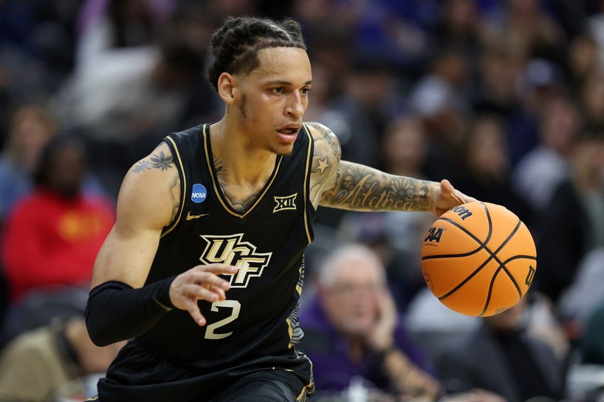 UCF Knights guard Riley Kugel (2) dribbles the ball UCLA Bruins in the first half during a first round game of the men's 2026 NCAA Tournament at Xfinity Mobile Arena.
