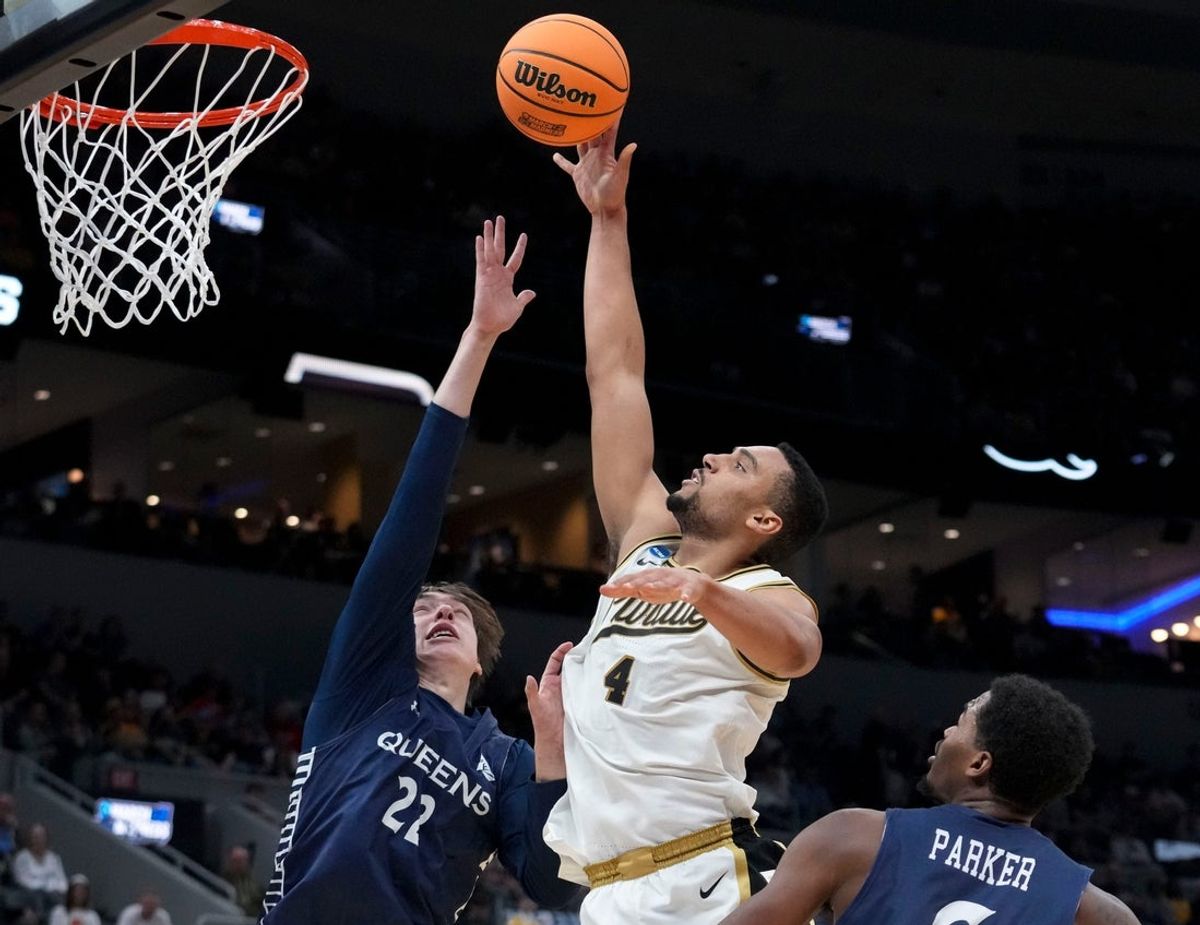 Purdue Boilermakers forward Trey Kaufman-Renn (4) shoots and scores while being defended by Queens University of Charlotte Royals forward Carson Schwieger (22) and forward Avantae Parker (6) during a NCAA Tournament first round game against the Queens University of Charlotte Royals on Friday, March 20, 2026, at Enterprise Center in St. Louis.