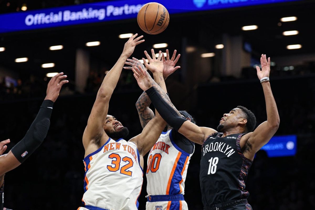 Mar 20, 2026; Brooklyn, New York, USA; New York Knicks center Karl-Anthony Towns (32) and guard Jordan Clarkson (00) rebound against Brooklyn Nets guard Malachi Smith (18) during the first half at Barclays Center. Mandatory Credit: Vincent Carchietta-Imagn Images