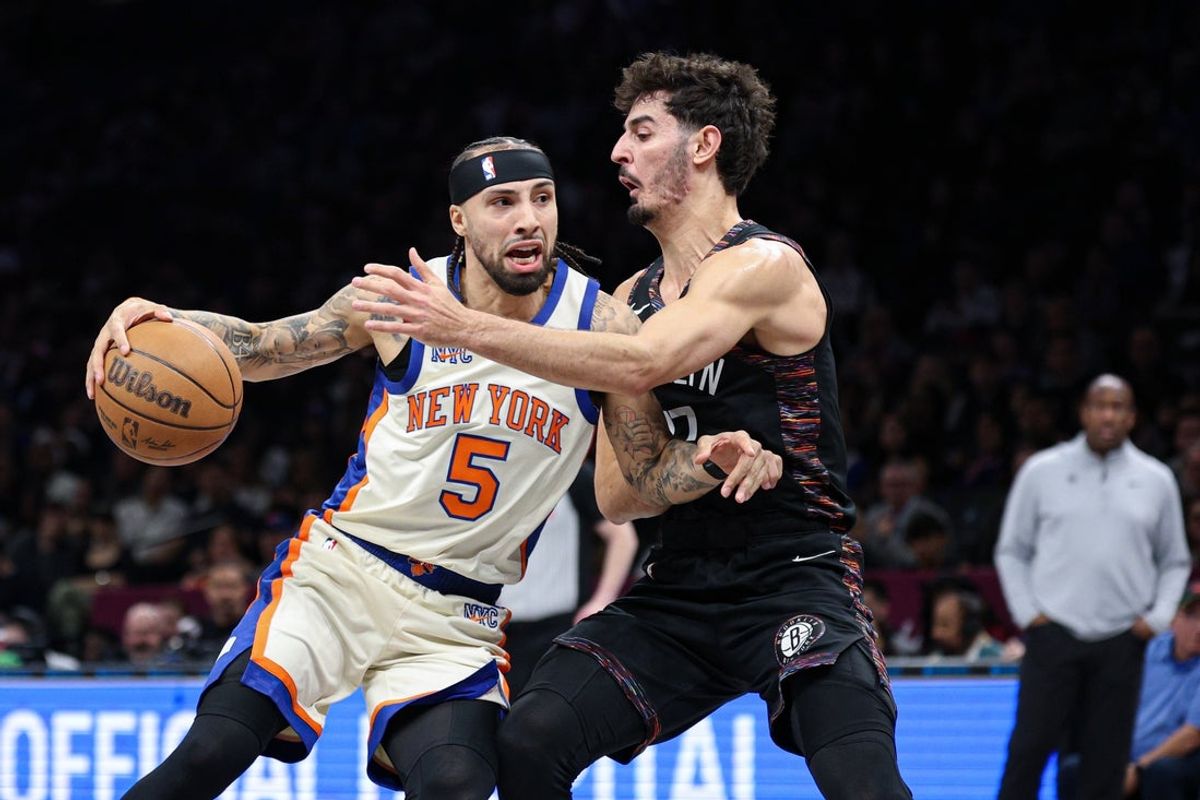 Mar 20, 2026; Brooklyn, New York, USA; New York Knicks guard Jose Alvarado (5) is guarded by Brooklyn Nets guard Ben Saraf (77) during the first half at Barclays Center. Mandatory Credit: Vincent Carchietta-Imagn Images