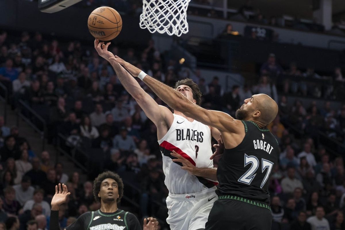 Mar 20, 2026; Minneapolis, Minnesota, USA; Portland Trail Blazers forward Deni Avdija (8) drives to the basket past Minnesota Timberwolves center Rudy Gobert (27) in the first half at Target Center. Mandatory Credit: Jesse Johnson-Imagn Images