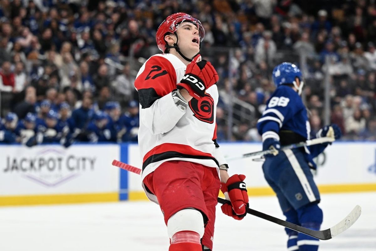 Mar 20, 2026; Toronto, Ontario, CAN;  Carolina Hurricanes defenseman Alexander Nikishin (21) celebrates after scoring the winning goal in overtime against the Toronto Maple Leafs at Scotiabank Arena. Mandatory Credit: Dan Hamilton-Imagn Images