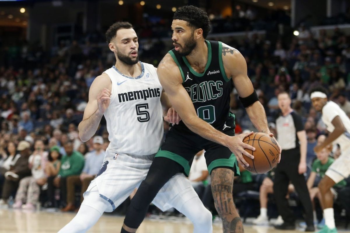 Mar 20, 2026; Memphis, Tennessee, USA; Boston Celtics forward Jayson Tatum (0) handles the ball as Memphis Grizzlies forward Tyler Burton (5) defends during the third quarter at FedExForum. Mandatory Credit: Petre Thomas-Imagn Images