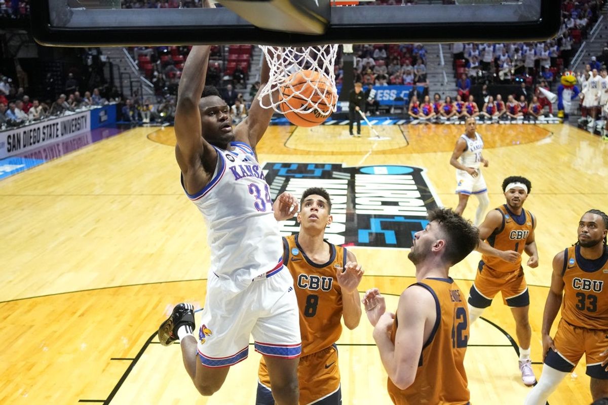 Mar 20, 2026; San Diego, CA, USA; Kansas Jayhawks center Paul Mbiya (34) dunks against the California Baptist Lancers in the first half during a first round game of the men's 2026 NCAA Tournament at Viejas Arena. Mandatory Credit: Kirby Lee-Imagn Images