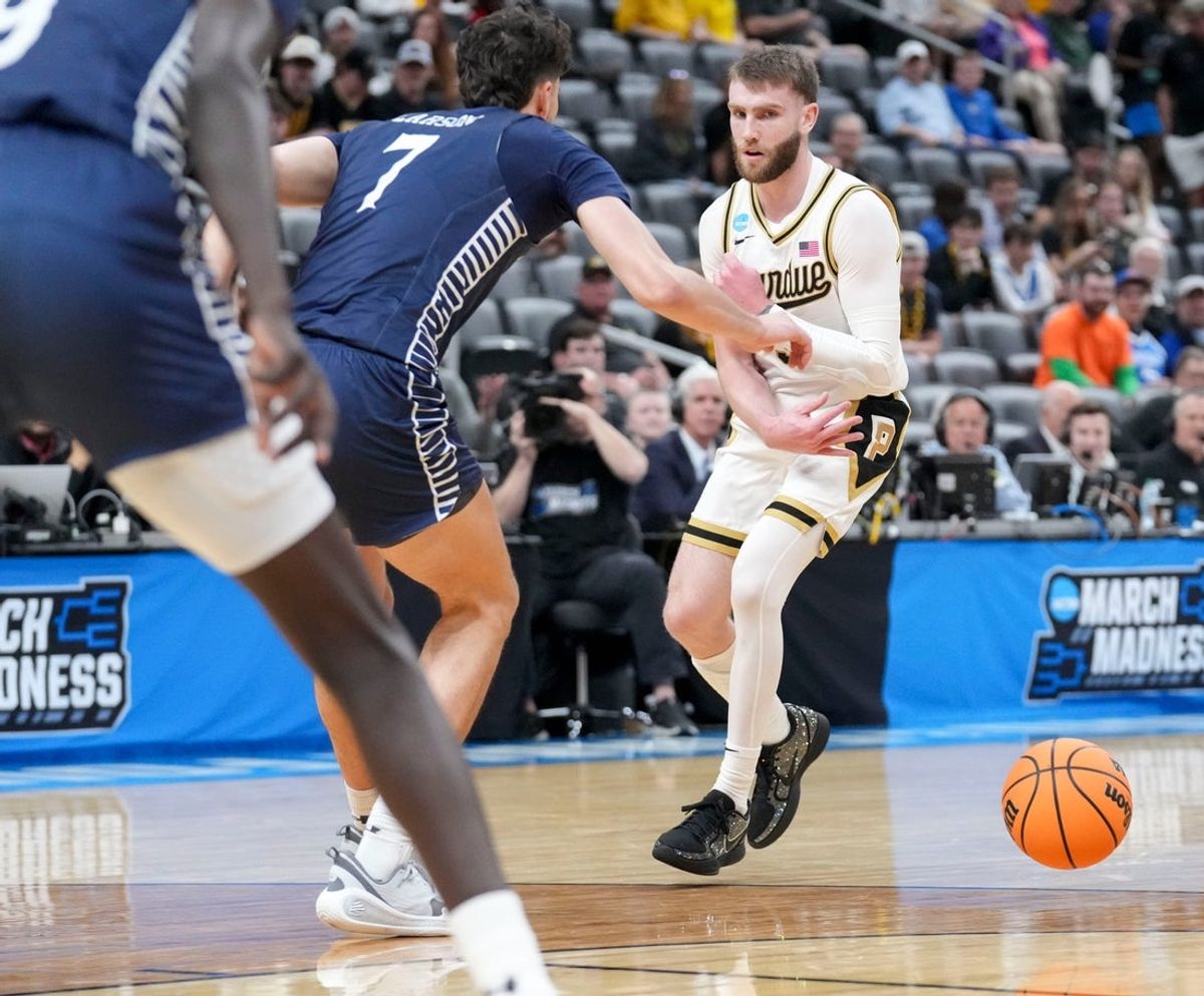 Purdue Boilermakers guard Braden Smith (3) passes the ball while being defended by Queens University of Charlotte Royals forward Gus Larson (7) during a NCAA Tournament first round game Friday, March 20, 2026, at Enterprise Center in St. Louis.