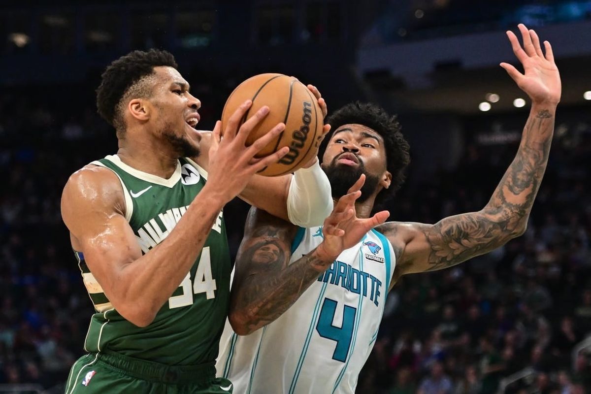 Feb 27, 2024; Milwaukee, Wisconsin, USA; Milwaukee Bucks forward Giannis Antetokounmpo (34) drives for the basket against Charlotte Hornets center Nick Richards (4) in the third quarter at Fiserv Forum.