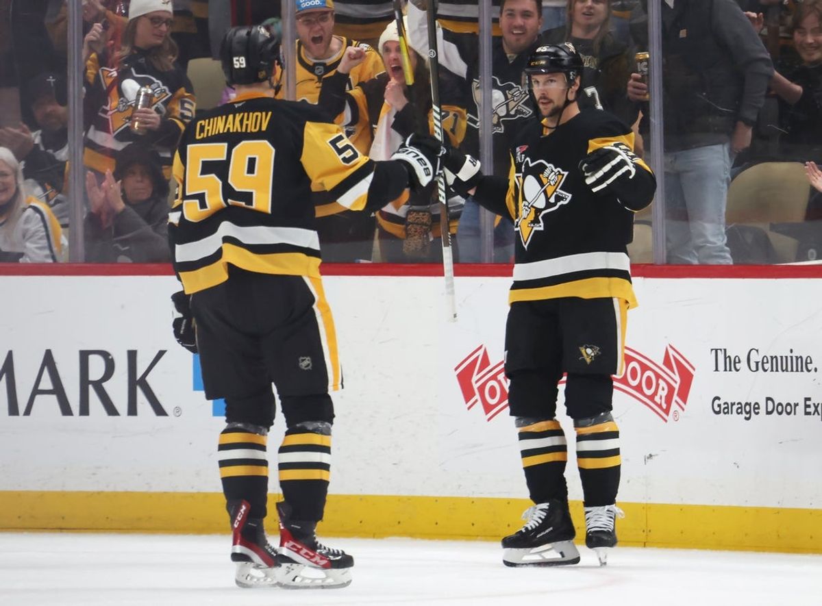 Mar 21, 2026; Pittsburgh, Pennsylvania, USA;  Pittsburgh Penguins defenseman Erik Karlsson (right) reacts with right wing Egor Chinakhov (59) after scoring a goal against the Winnipeg Jets during the second period at PPG Paints Arena. Mandatory Credit: Charles LeClaire-Imagn Images