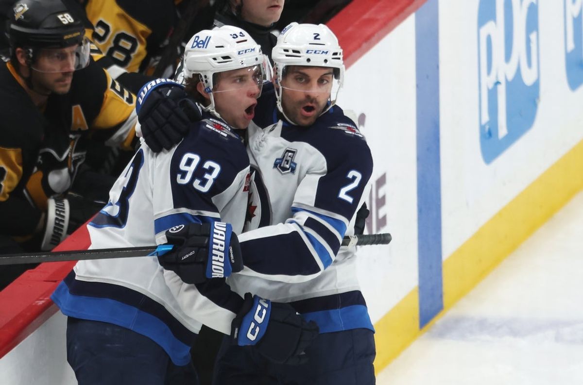 Mar 21, 2026; Pittsburgh, Pennsylvania, USA;  Winnipeg Jets center Brad Lambert (93) and defenseman Dylan DeMelo (2) celebrate a goal by Lambert against the Pittsburgh Penguins during the third period at PPG Paints Arena. Mandatory Credit: Charles LeClaire-Imagn Images