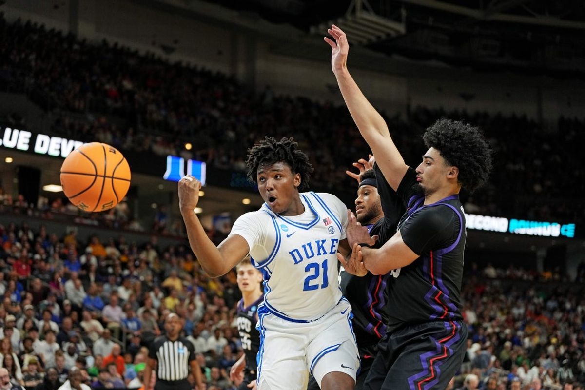 Mar 21, 2026; Greenville, SC, USA; Duke Blue Devils center Patrick Ngongba (21) loses the ball against Texas Christian University Horned Frogs forward David Punch (15) during the second half during a second round game of the men's 2026 NCAA Tournament at Bon Secours Wellness Arena. Mandatory Credit: Bob Donnan-Imagn Images