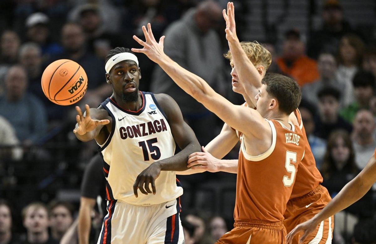 Mar 21, 2026; Portland, OR, USA; Gonzaga Bulldogs forward Graham Ike (15) passes against Texas Longhorns forward Camden Heide (5) in the first half during a second round game of the men's 2026 NCAA Tournament at Moda Center. Mandatory Credit: Craig Strobeck-Imagn Images