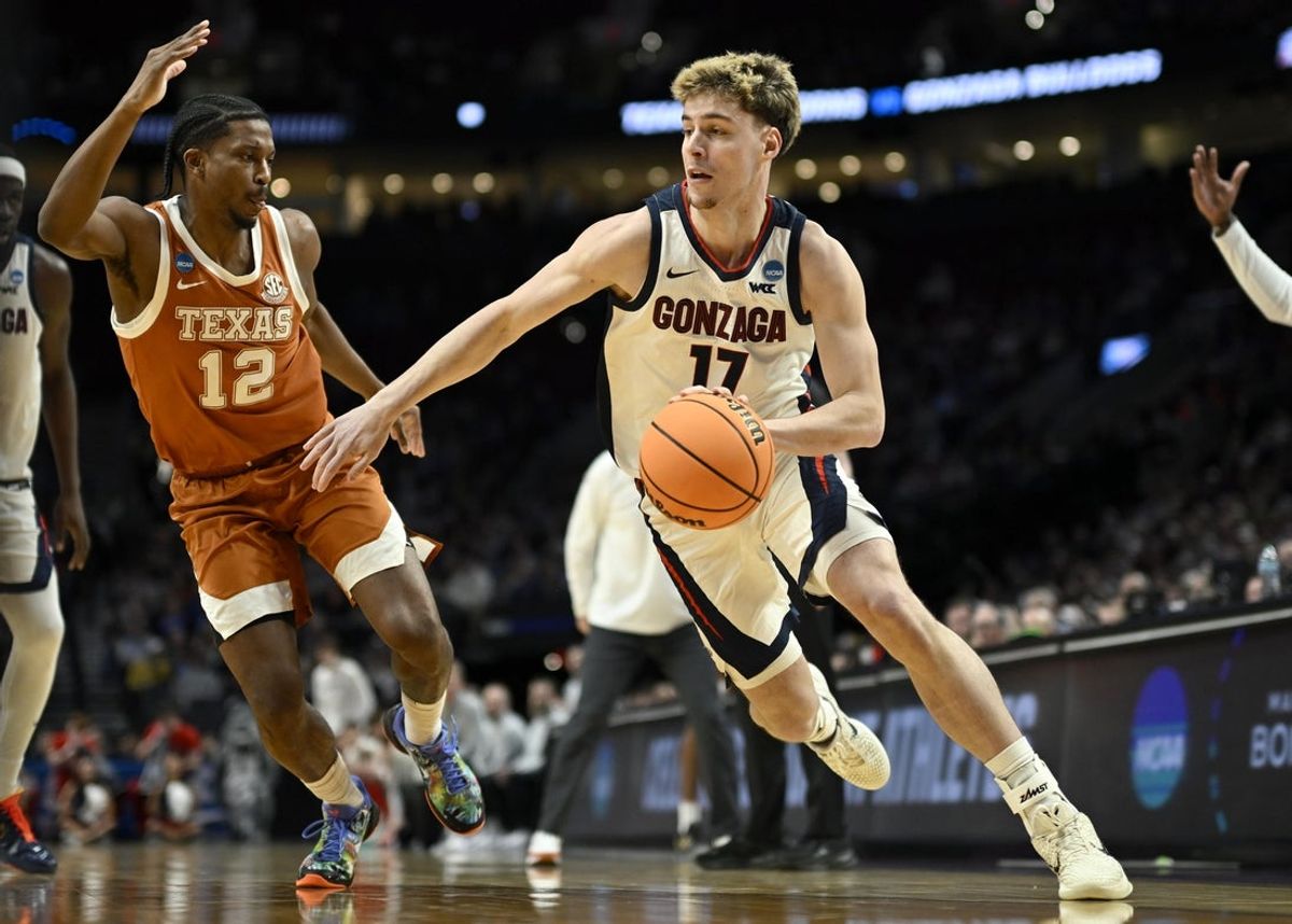Mar 21, 2026; Portland, OR, USA; Gonzaga Bulldogs guard Mario Saint-Supery (17) drives against Texas Longhorns guard Tramon Mark (12) in the first half during a second round game of the men's 2026 NCAA Tournament at Moda Center. Mandatory Credit: Troy Wayrynen-Imagn Images