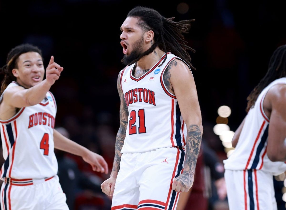 Houston's Emanuel Sharp (21) and Kingston Flemings celebrate during a second-round game in the NCAA men's basketball tournament between Houston Cougars and Texas A&M Aggies at Paycom Center in Oklahoma City, Saturday March 21, 2026.