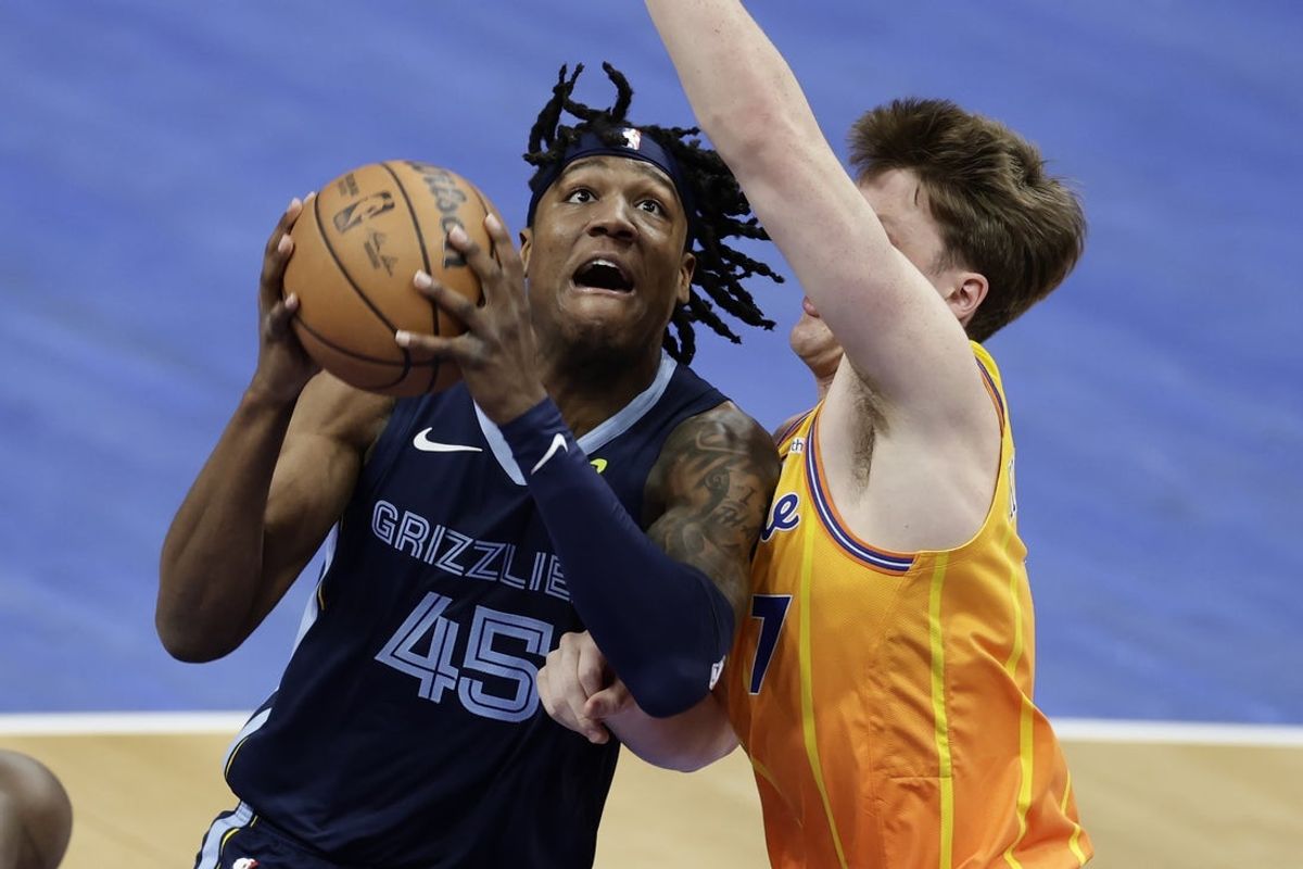 Mar 21, 2026; Charlotte, North Carolina, USA; Memphis Grizzlies forward GG Jackson (45) drives to the basket past Charlotte Hornets guard/forward Kon Knueppel (7) during the first quarter at Spectrum Center. Mandatory Credit: Brian Westerholt-Imagn Images