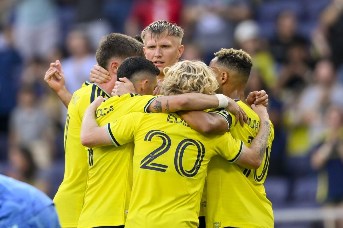 Mar 21, 2026; Nashville, Tennessee, USA;  Nashville SC forward Sam Surridge (9) celebrates with his teammates after scoring a goal against the Orlando City during the first half at Geodis Park. Mandatory Credit: Steve Roberts-Imagn Images