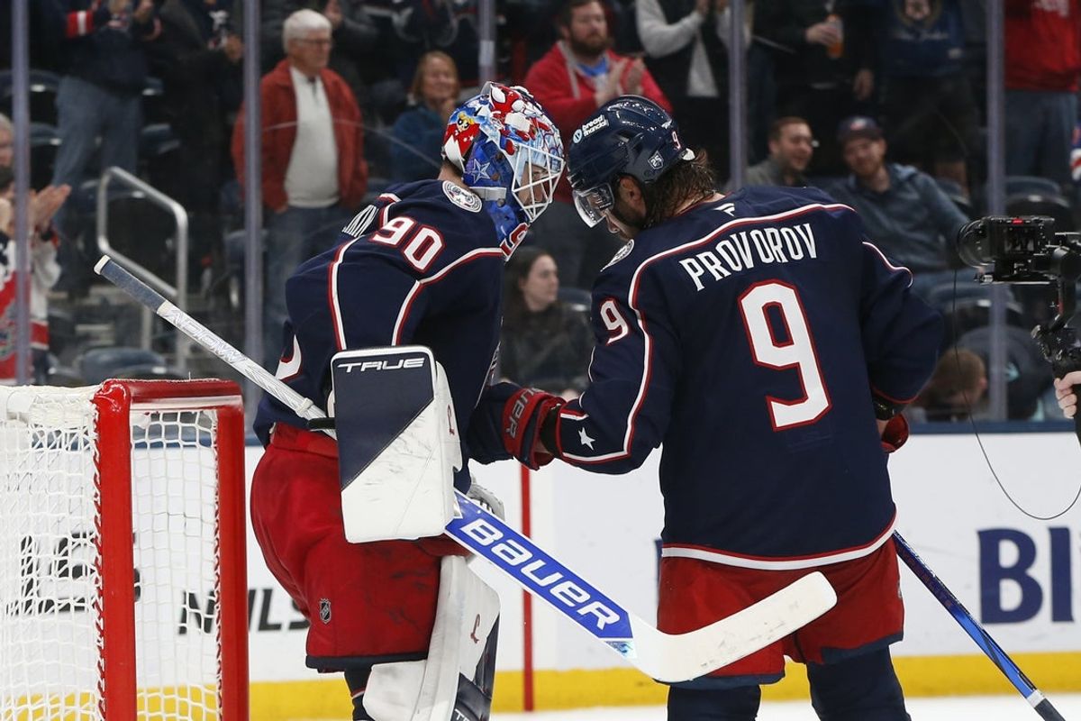 Mar 21, 2026; Columbus, Ohio, USA; Columbus Blue Jackets goalie Elvis Merzlikins (90) and defenseman Ivan Provorov (9) celebrate the win over the Seattle Kraken after the game at Nationwide Arena. Mandatory Credit: Russell LaBounty-Imagn Images