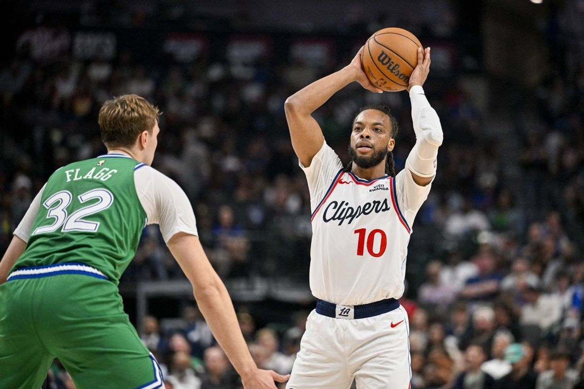 Mar 21, 2026; Dallas, Texas, USA; LA Clippers guard Darius Garland (10) looks to pass the ball over Dallas Mavericks forward Cooper Flagg (32) during the second quarter at the American Airlines Center. Mandatory Credit: Jerome Miron-Imagn Images