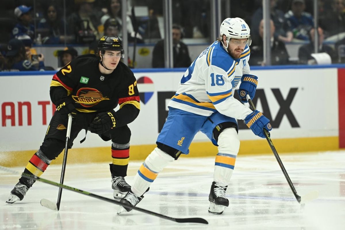 Mar 21, 2026; Vancouver, British Columbia, CAN;  St. Louis Blues center Robert Thomas (18) skates with the puck against Vancouver Canucks left wing Liam Ohgren (92) during the third period at Rogers Arena. Mandatory Credit: Simon Fearn-Imagn Images