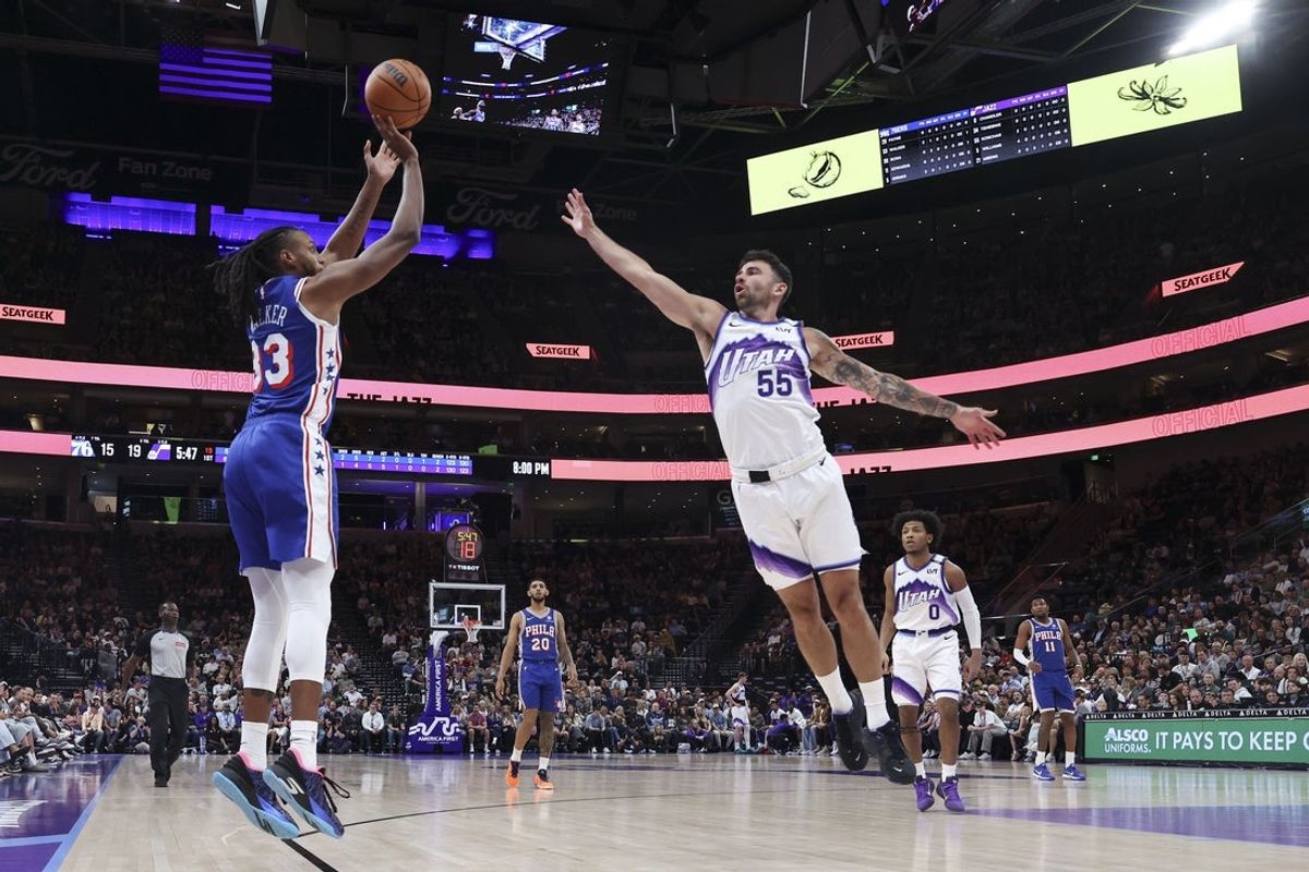 Mar 21, 2026; Salt Lake City, Utah, USA; Philadelphia 76ers forward Jabari Walker (33) goes up for a shot against Utah Jazz guard John Konchar (55) during the first half at Delta Center. Mandatory Credit: Rob Gray-Imagn Images