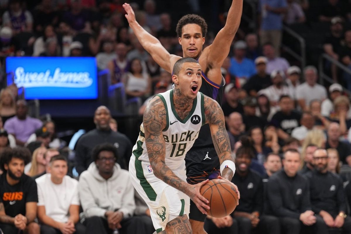 Mar 21, 2026; Phoenix, Arizona, USA; Milwaukee Bucks forward Kyle Kuzma (18) drives against Phoenix Suns forward Oso Ighodaro (11) during the second half at Mortgage Matchup Center. Mandatory Credit: Joe Camporeale-Imagn Images