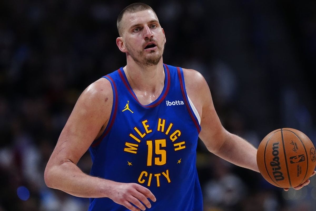 Mar 22, 2026; Denver, Colorado, USA; Denver Nuggets center Nikola Jokic (15) controls the ball in the first quarter against the Portland Trail Blazers at Ball Arena. Mandatory Credit: Ron Chenoy-Imagn Images