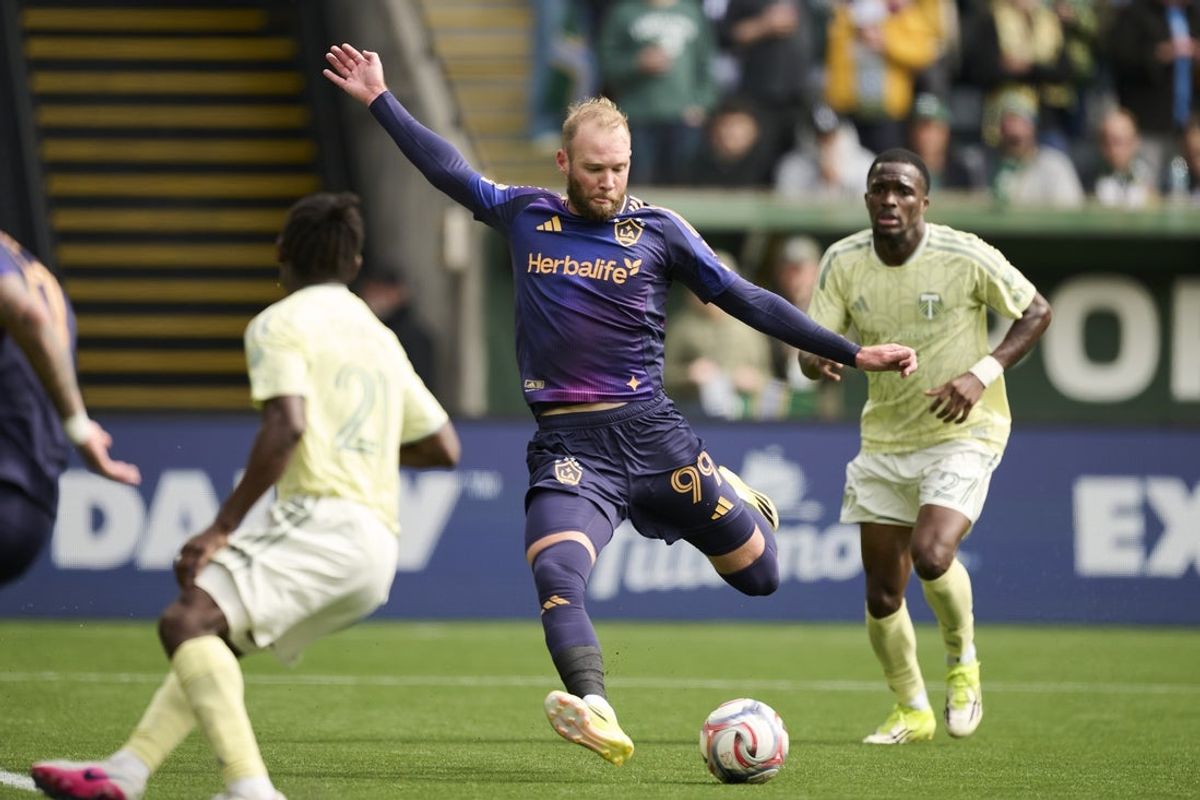 Mar 22, 2026; Portland, Oregon, USA; Los Angeles Galaxy forward Joao Klauss (99) scores a goal during the first half against Portland Timbers midfielder Jimer Fory (27) at Providence Park. Mandatory Credit: Troy Wayrynen-Imagn Images